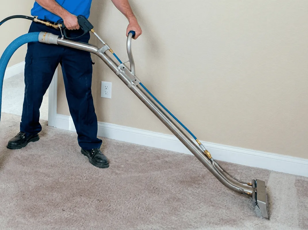 Professional operating a liquid removal machine on a carpeted floor in Chattanooga, TN